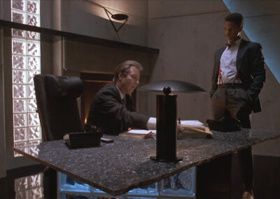 Glass block strip on wall and under desk in The Big Picture (1989)